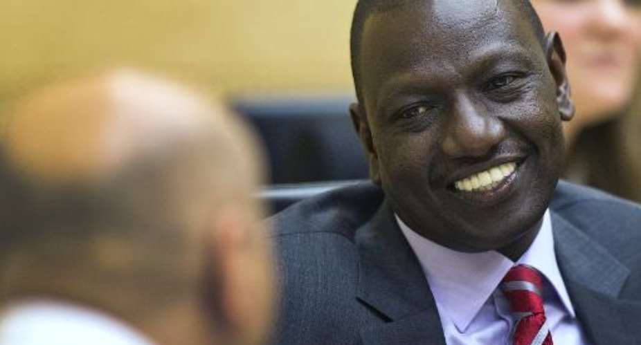 Kenya's Vice President William Ruto speaks with his defense counsel Karim Khan L before the start of his trial at the International Criminal Court ICC in The Hague on September 10, 2013.  By Michael Kooren PoolAFPFile