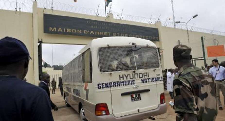A national gendarmerie van carrying prisoners enters the gates of the Maison d'Arret et de Correction d'Abidjan Maca, Ivory Coast's largest prison, on August 16, 2011.  By Sia Kambou AFPFile