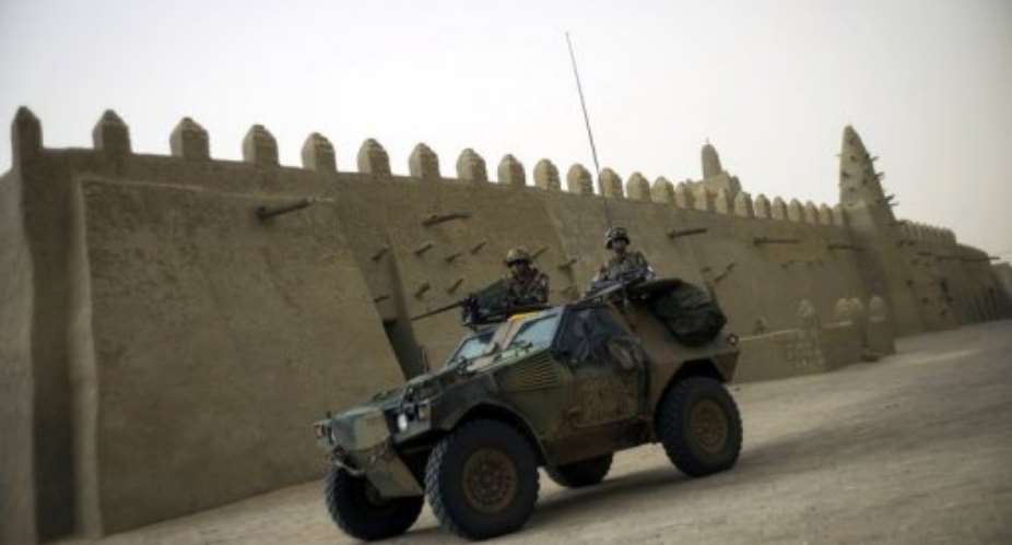French soldiers patrol in an armoured vehicle next to the Djingareyber mosque, on January 31, 2013 in Timbuktu.  By Fred Dufour AFPFile