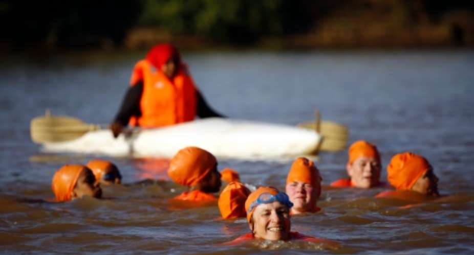 Sudanese and Dutch women take part in an event to swim across the Blue Nile in the capital Khartoum on November 21, 2015, as part of an event organised by Dutch ambassador Susan Blankhart.  By Ashraf Shazly AFP