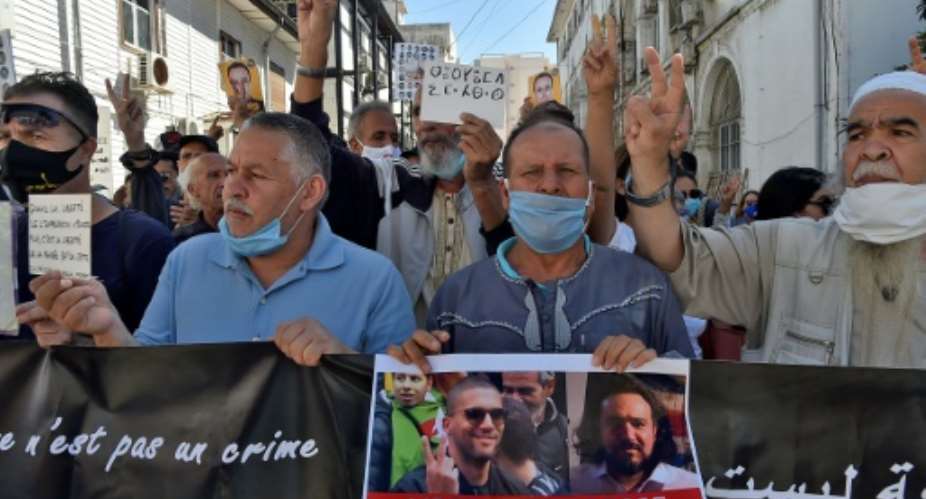 An Algerian demonstrator held up a sign reading in French 'Free the Press' at a protest in the capital Algiers calling for the release of jailed journalist Khaled Drareni in September.  By RYAD KRAMDI AFPFile