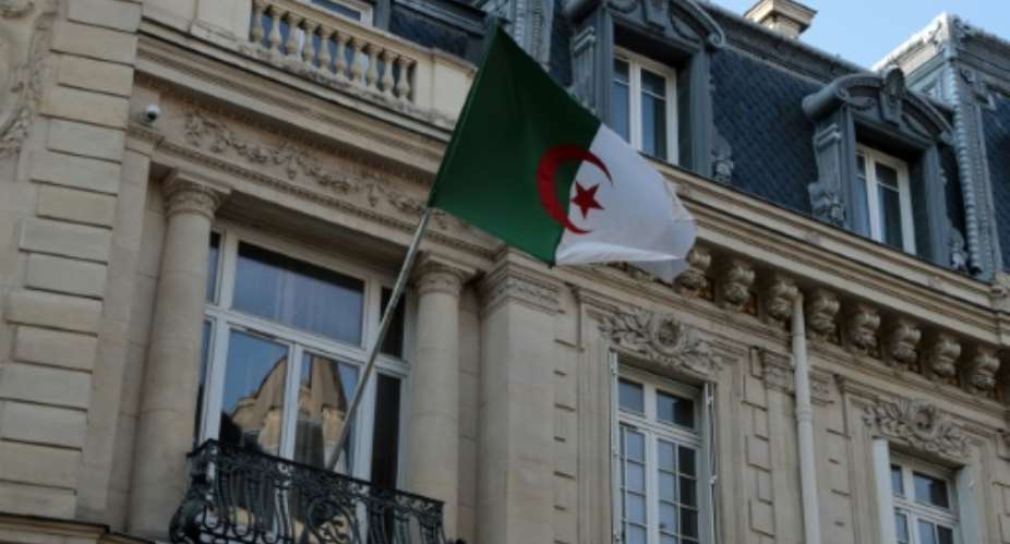 An Algerian flag flutters on the facade of the embassy in Paris in July 2021.  By Jol SAGET AFPFile