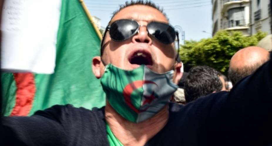 An Algerian man take part in a protest in the capital Algiers demanding an independent judiciary.  By RYAD KRAMDI AFP