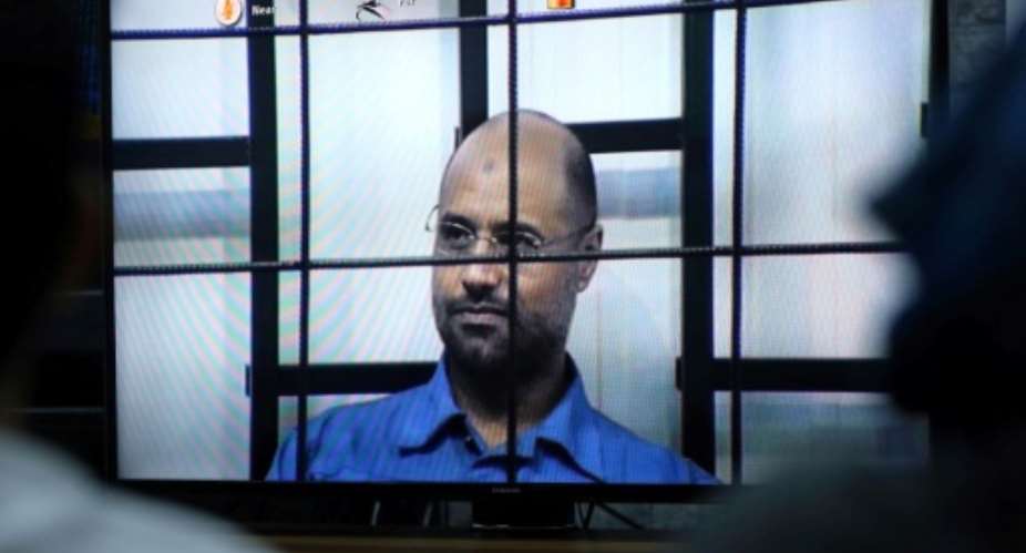 An armed group in Libya said on Facebook on June 10, 2017, it has freed Seif al-Islam who has been in custody since November 2011, pictured in 2014 answwering judges' questions in Tripoli.  By MAHMUD TURKIA AFPFile