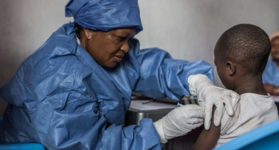 An Ebola case has been reported in the Democratic Republic of Congo, five months after the latest epidemic there was declared over -- here, a girl is given an Ebola vaccine in November 2019 in Goma.  By PAMELA TULIZO AFPFile