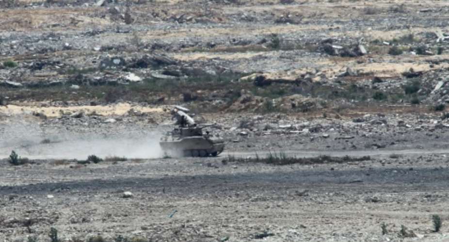 An Egyptian armored vehicle patrols the Sinai Peninsula bordering the Gaza Strip.  By SAID KHATIB AFPFile