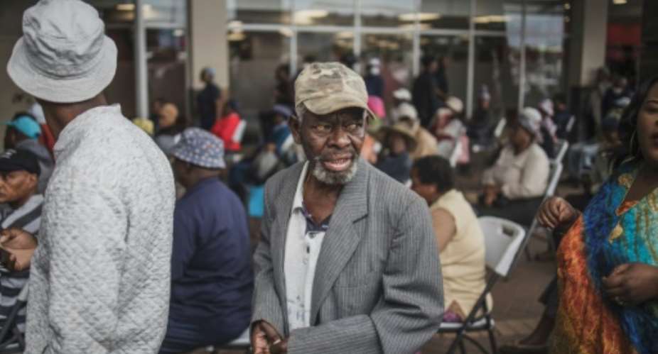 An elderly man from Soweto queues to collect his social grant.  By MARCO LONGARI AFP