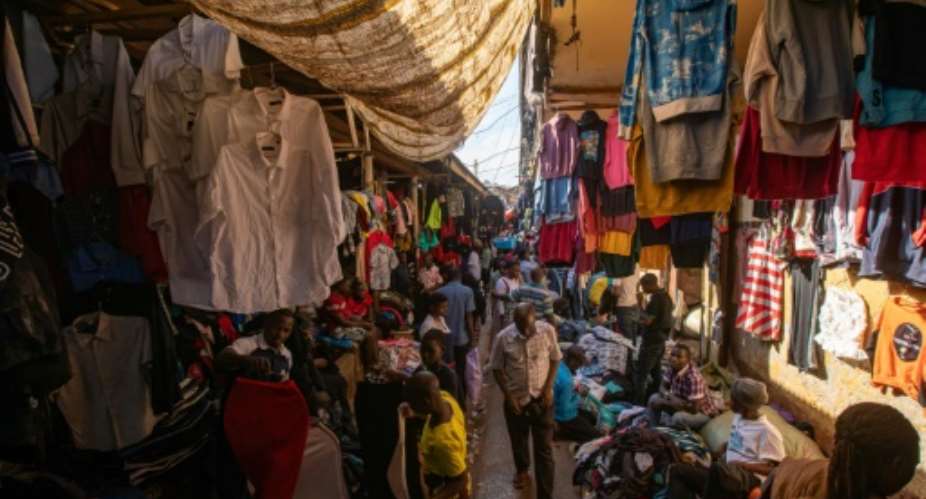 An estimated 16 million Ugandans -- one in every three -- wear used clothing.  By BADRU KATUMBA AFP
