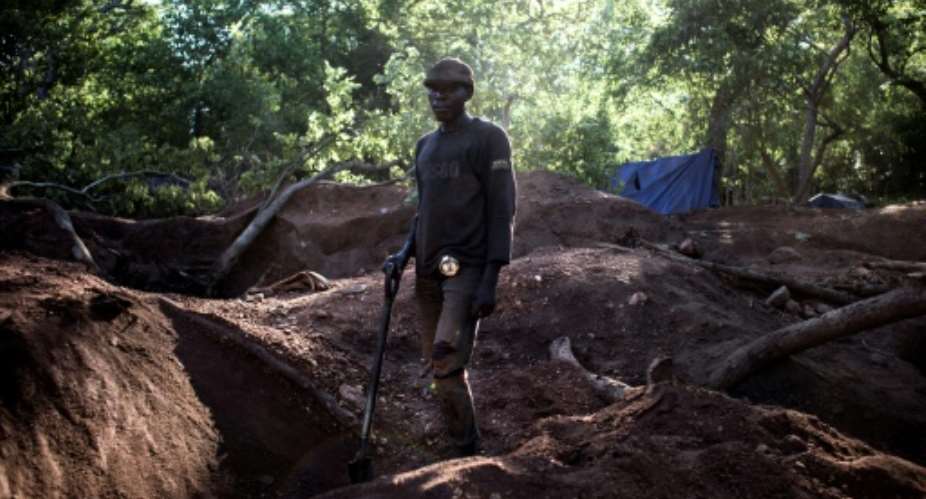 An illegal miner stands in an area rich with gold and rubies on the outskirts of Montepuez, Mozambique.  By John Wessels AFPFile