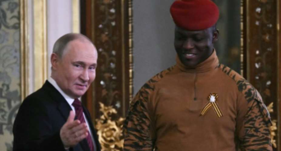 Analysts say the campaign glorifying Burkina Fasos junta leader Captain Ibrahim Traore (R) helps Russias interests.  By Angelos Tzortzinis (AFP)