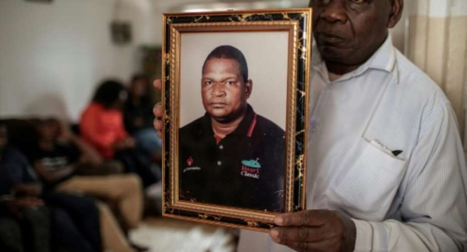 Anastacio Matavele, seen here in a portrait held by a family representative, was killed in the run-up to Mozambique's October election.  By GIANLUIGI GUERCIA AFP