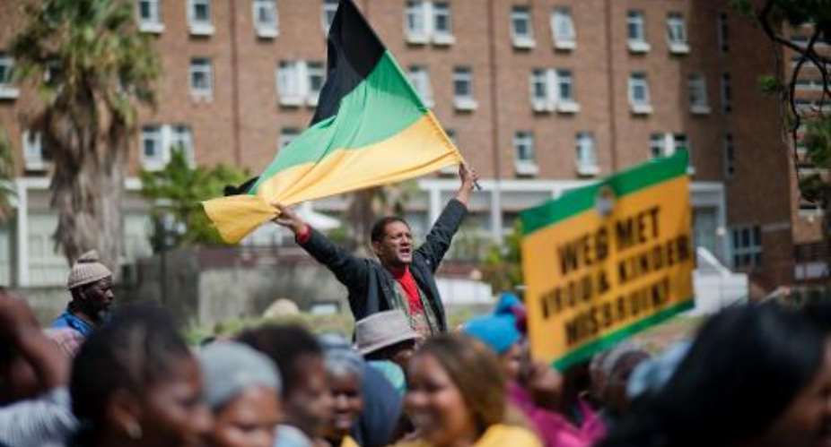 A man waves an ANC flag as supporters of the ruling party take part in a protest on March 26, 2014,  in Cape Town.  By Rodger Bosch AFPFile