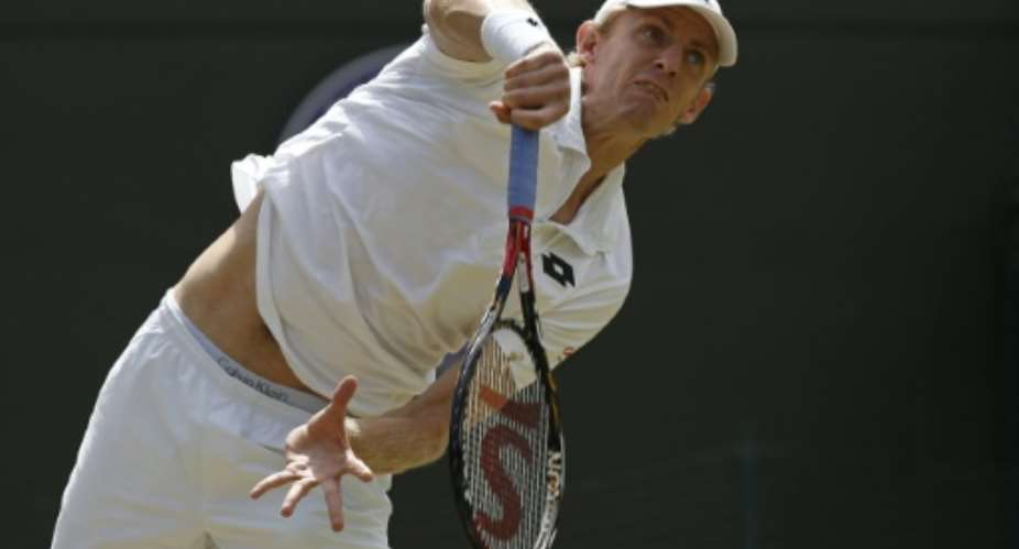 South Africa's Kevin Anderson serves against Serbia's Novak Djokovic during their men's singles fourth round match in Wimbledon on July 7, 2015.  By Adrian Dennis AFP