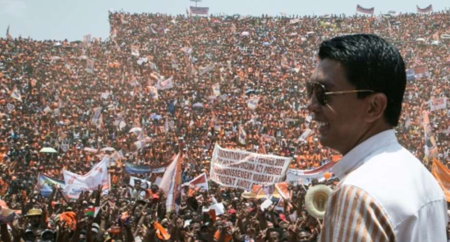 Andry Rajoelina, pictured here at a campaign rally, is ahead in Madagascar's vote count. He is on course for a runoff on December 19 against another former president, Marc Ravalomanana.  By RIJASOLO AFP