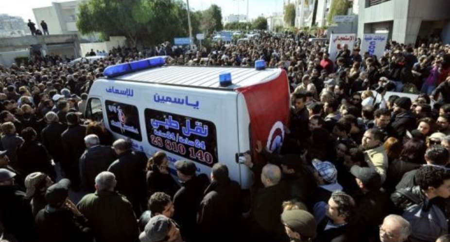 An ambulance takes the body of Chokri Belaid to hospital in Tunis after he was shot dead on February 6, 2013.  By Fethi Belaid AFP
