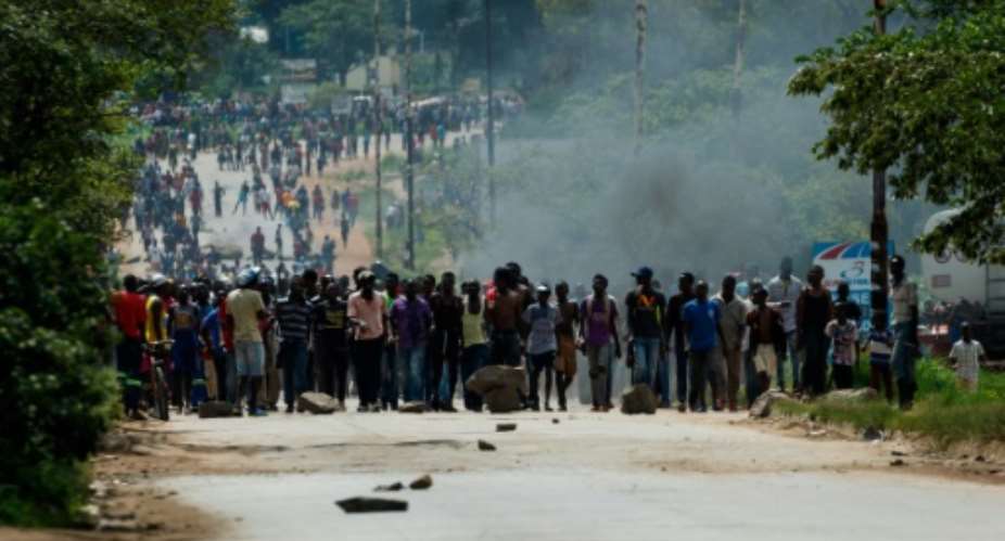 Angry protesters barricade the main route to Zimbabwe's capital Harare from Epworth township in January 2019 demonstrations against a hike in fuel prices.  By Jekesai NJIKIZANA AFPFile