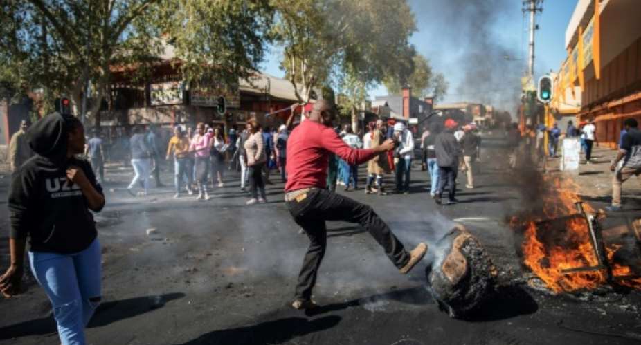 Angry protesters looted alleged foreign-owned shops in Johannesburg in a new wave of violence.  By Michele Spatari AFP