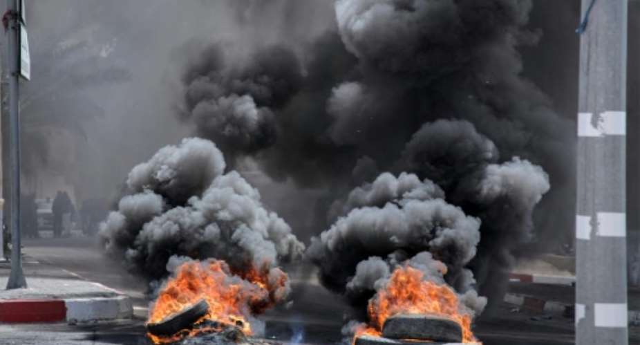 Angry residents block roads in the Tunisian town of Mezzouna after the deaths of three six-formers in a school wall collapse on Monday..  By SABER SBOUI (AFP)