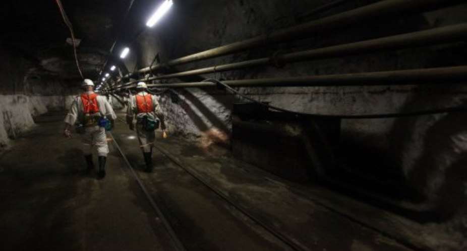 Mine workers walk in a platinum mine in South Africa.  By Paballo Thekiso AFPFile