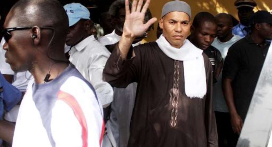 The son of former Senegalese leader Abdoulaye Wade, Karim, waves while being arrested on April 15, 2013 in Dakar.  By  AFPFile