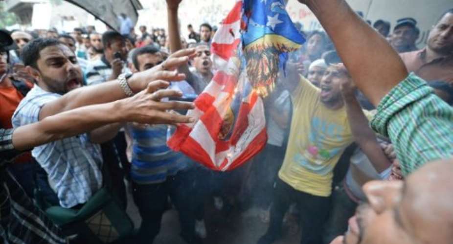 Egyptian protesters burn the US flag outside the US embassy in Cairo during a demonstration against a film.  By Khaled Desouki AFP
