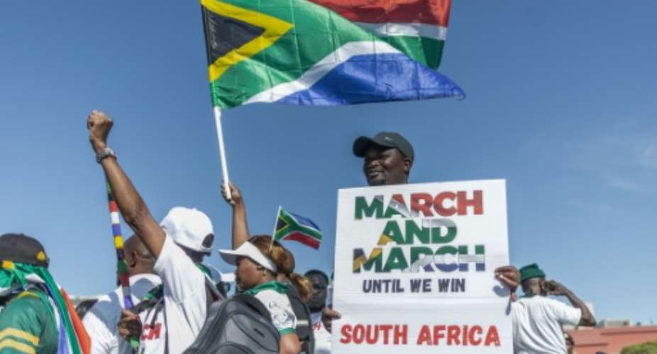 Anti-migrant protesters gathered outside the venue of a southern Africa regional summit.  By RAJESH JANTILAL (AFP)