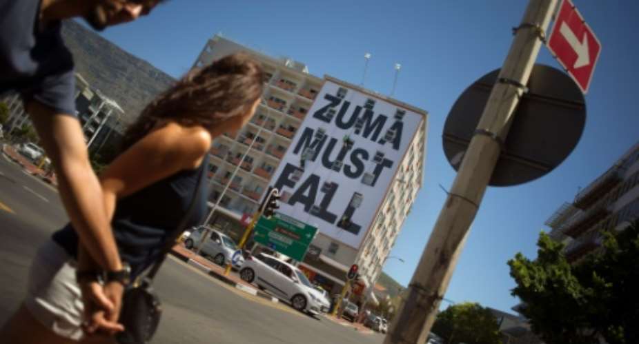 A giant banner in central Cape Town reads Zuma must fall.  By Rodger Bosch AFPFile