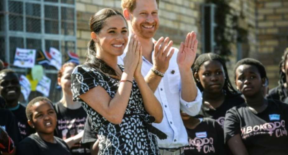 Applause: Prince Harry and Meghan visited a Cape Town rights group fighting gender violence. Rape and murder of women have reached epidemic proportions in South Africa.  By Courtney AFRICA POOLAFP