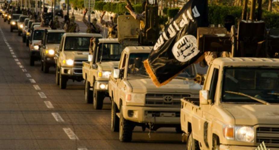 An image made available by propaganda Islamist media outlet Welayat Tarablos in February 2015, allegedly shows members of the Islamic State IS militant group parading in a street in Libya's coastal city of Sirte.  By - Welayat TarablosAFPFile