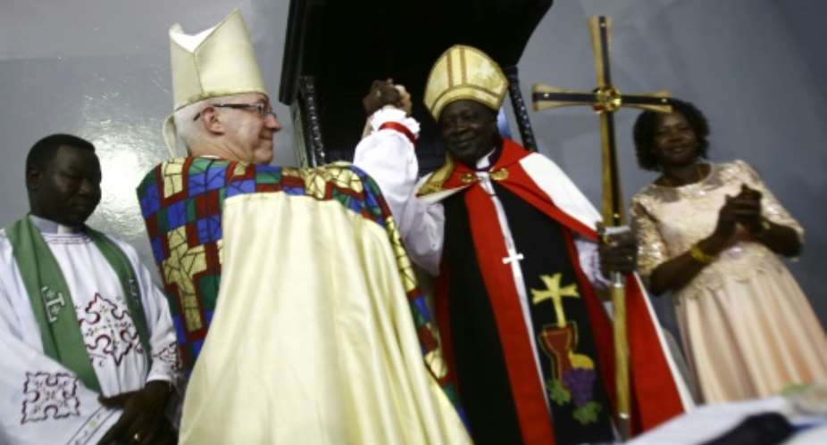 Archbishop of Canterbury Justin Welby and Ezekiel Kondo Kumir Kuku take part in a ceremony installing Kuku as Sudan's first archbishop at Khartoum's All Saints Cathedral on July 30, 2017.  By ASHRAF SHAZLY AFP