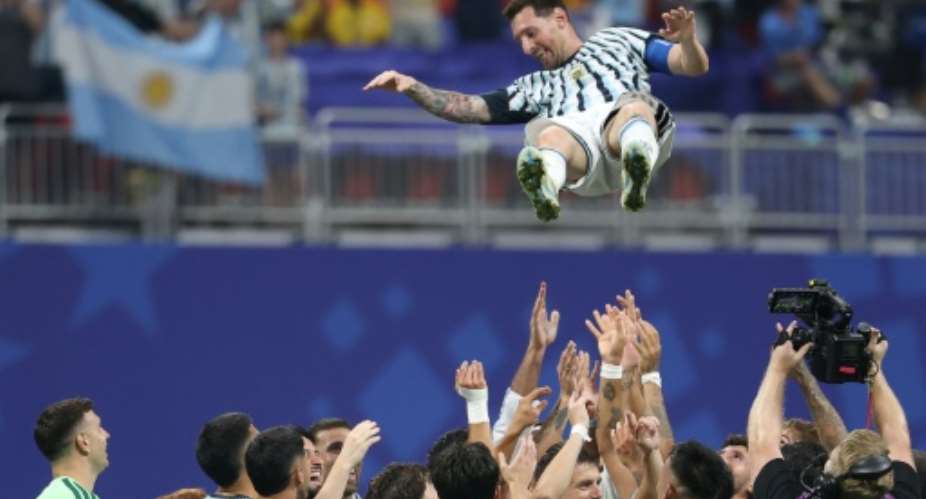 Argentina forward Lionel Messi is tossed into the air by team-mates after inspiring a late fightback in a 3-2 victory over Egypt.  By Odd ANDERSEN (AFP)