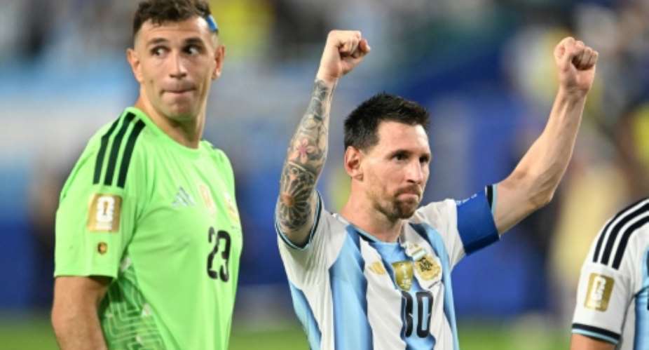Argentinas Lionel Messi celebrates with goalkeeper Emiliano Martinez after his teams extra-time win over Cape Verde.  By ROBERTO SCHMIDT (AFP)