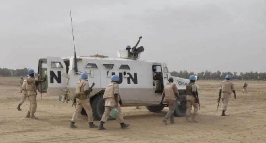 UN peacekeepers patrol on May 12, 2015 in Timbuktu, where nine Malian soldiers were killed by the rebel Coordination of Azawad Movements the day before.  By Alou Sissoko AFPFile
