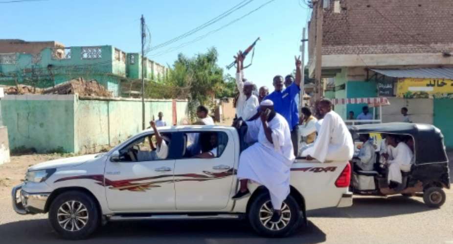 Armed Sudanese civilians wave weapons and chant slogans in support of the army, in Gedaref city.  By - AFPFile