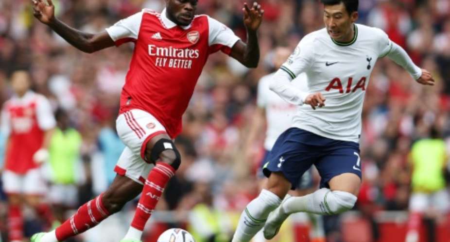 Arsenal midfielder Thomas Partey L attacks against Tottenham Hotspur in an English Premier League match on October 1, 2022..  By Adrian DENNIS AFP