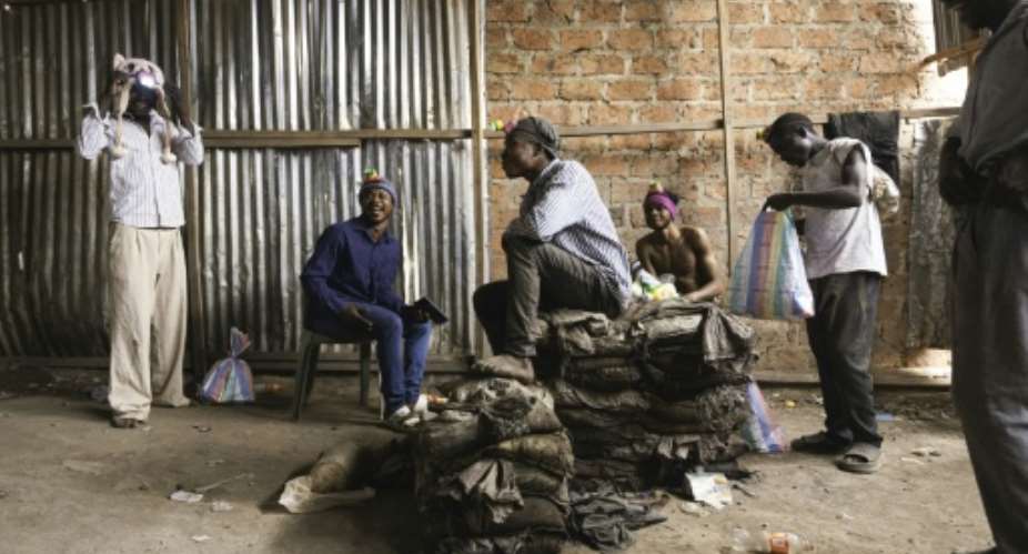 Artisanal miners prepare to descend into the mine shaft,  in Kolwezi, where the race is on for critical minerals as the boundary between urban space and mining land fades.  By MARIE RUWET (AFP)