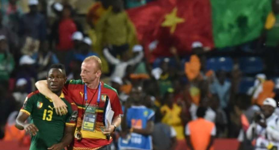 Assistant coach Sven Vandenbroeck R celebrates with midfielder Christian Bassogog after Cameroon won the 2017 Africa Cup of Nations in Libreville..  By ISSOUF SANOGO AFP