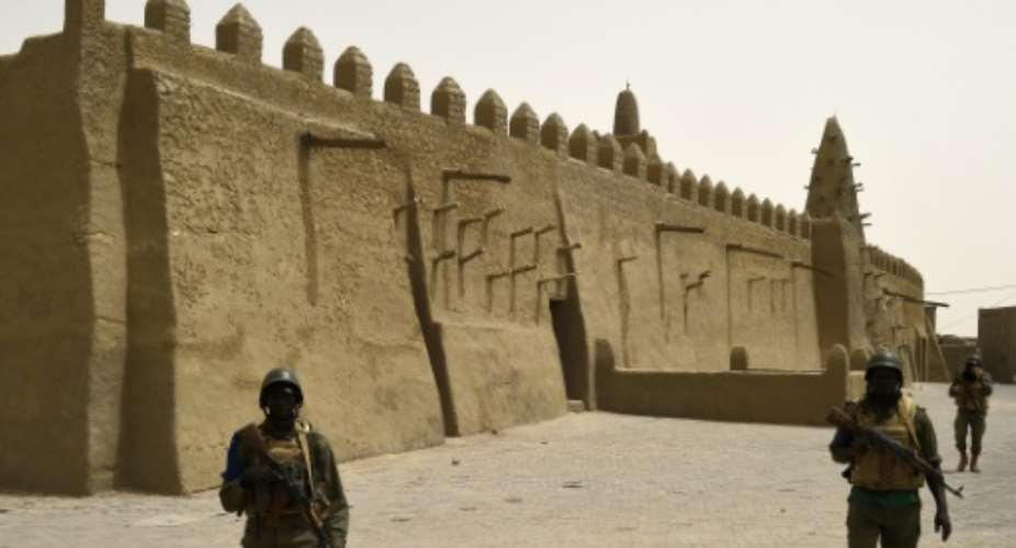 Mali soldiers patrol the Djingareyber Mosque in Timbuktu, on June 6, 2015.  By Philippe Desmazes AFP