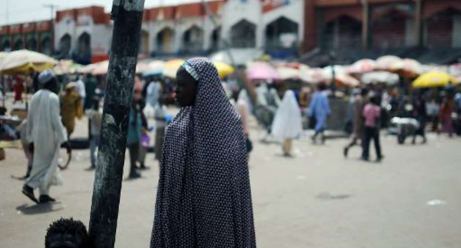 A veiled woman stands at the market in Maiduguri on June 6, 2012.  By Quentin Leboucher AFPFile