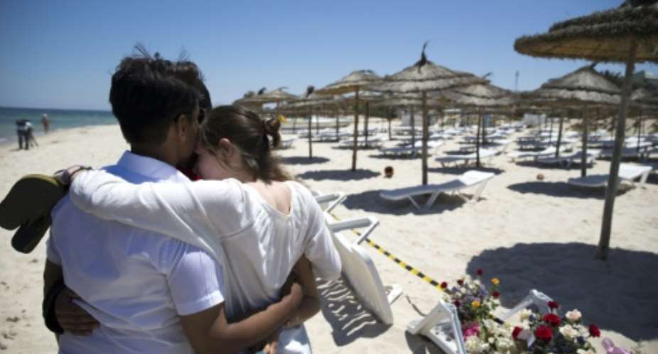 Tourists console each other at the site of a shooting attack on the beach in front of the Riu Imperial Marhaba Hotel in Port el Kantaoui, on the outskirts of Sousse south of the capital Tunis, on June 27, 2015.  By Kenzo Tribouillard AFPFile