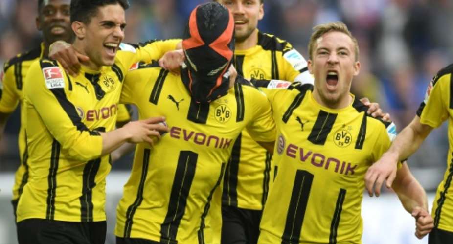 Aubameyang celebrates in trademark fashion with his Dortmund teammates after scoring against Schalke last season.  By PATRIK STOLLARZ (AFP/File)