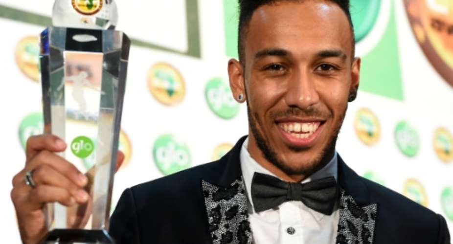 Gabonese striker Pierre-Emerick Aubameyang poses with the African Footballer of the Year Award during 2015 Glo-CAF Awards in Abuja, on January 7, 2016.  By Pius Utomi Ekpei AFPFile