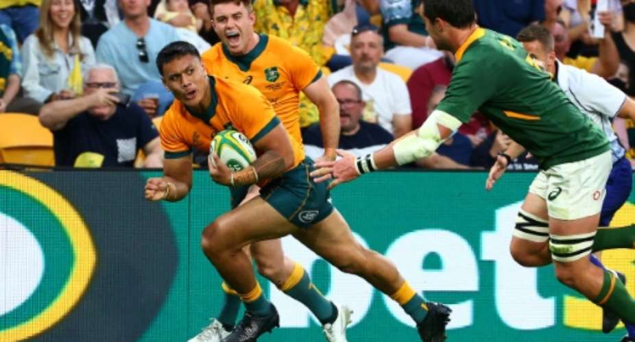 Australia's Len Ikitau scores one of his two tries against South Africa in Brisbane on Saturday.  By Patrick HAMILTON AFP