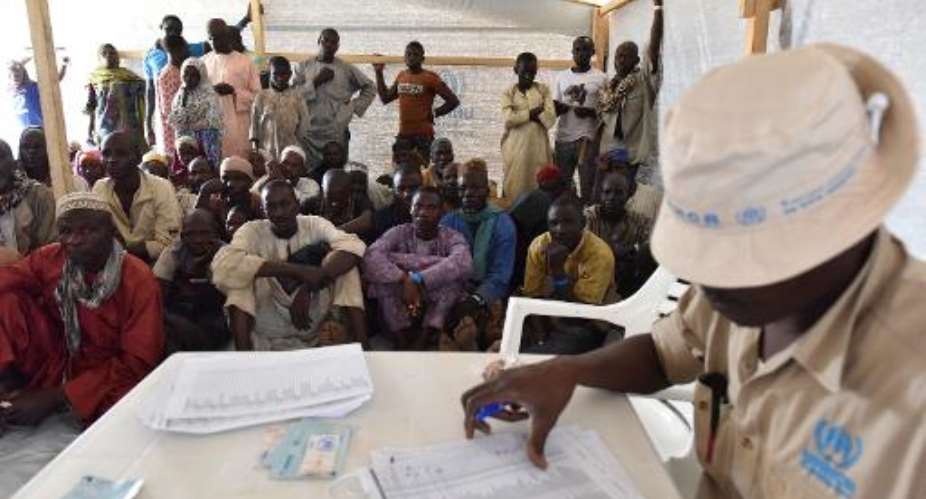 Nigerian refugees wait to be registered in a United Nations Refugee Agency UNHCR refugee camp in Baga Sola by Lake Chad, which borders Chad, Nigeria, Niger and Cameroon, on January 26, 2015.  By Sia Kambou AFPFile