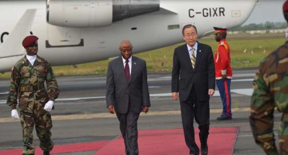 UN chief Ban Ki-moon R reviews the troops with Liberian Vice President Joseph Boakai after arriving at the Monrovia airport, on December 19, 2014, on the first stop of a visit to Ebola-ravaged west African countries.  By Zoom Dosso AFP