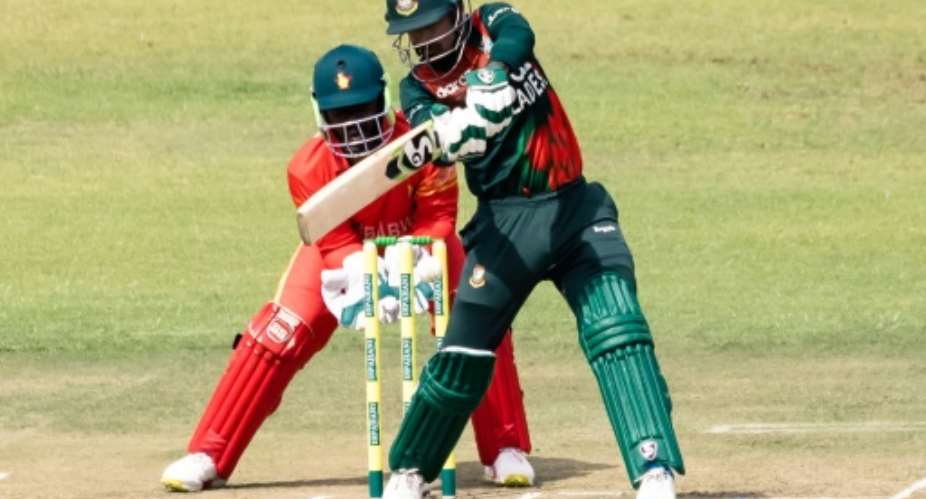 Bangladesh opening batsman Liton Das plays a shot as Zimbabwe wicketkeeper Regis Chakabva looks on during a one-day international at Harare Sports Club on Friday.  By Jekesai NJIKIZANA AFP