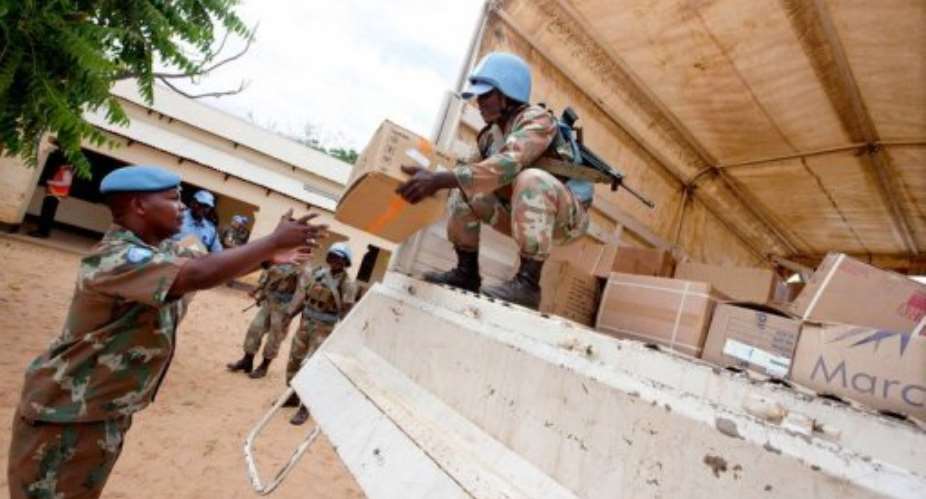 UN peacekeepers unload boxes of medical supplies to be delivered to a rural hospital in Kutum in North Darfur.  By Albert Gonzalez Farran AFPUNAMID