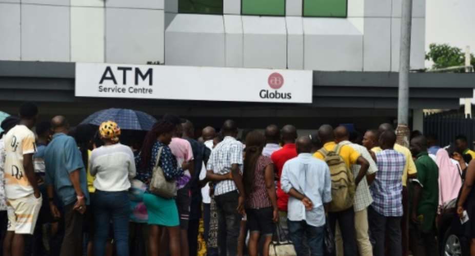 Banks have seen long lines as people wait for access to limited cash supplies since the central bank programme to replace old naira with new notes.  By PIUS UTOMI EKPEI (AFP)