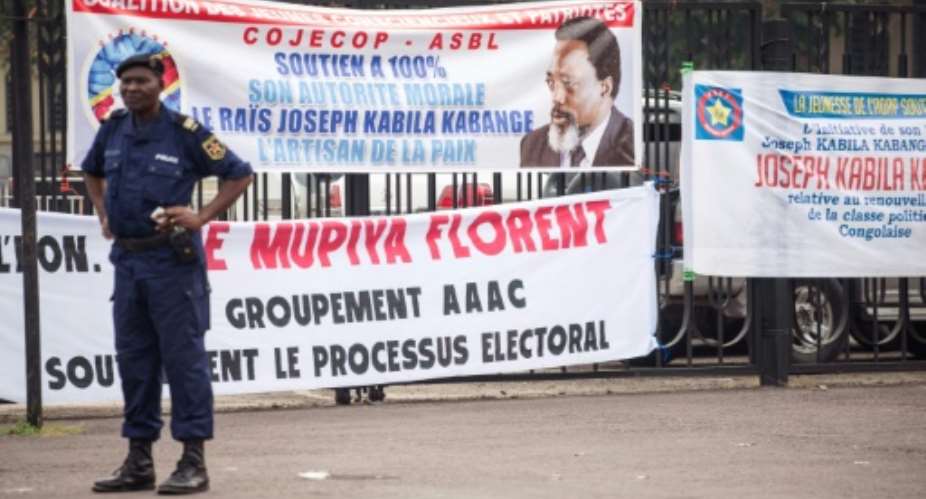 Banners are seen in support of President of the Democratic Republic of Congo, Joseph Kabila, who has promised to step down but still wields influence over who his successor might be.  By Junior D. KANNAH AFPFile