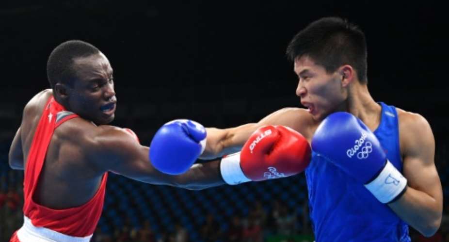 Kenyas Peter Mungai Warui fights Chinas Lv Bin in Rio on August 8, 2016.  By Yuri Cortez (AFP)